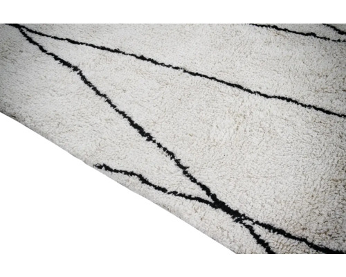 Wit vloerkleed met zwart lijnpatroon