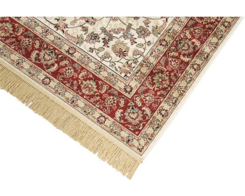 Detail van een vloerkleed met franjes en een bloemmotief