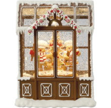 Decoratieve sneeuwbol in de vorm van een peperkoekhuis met peperkoekmannetjes
