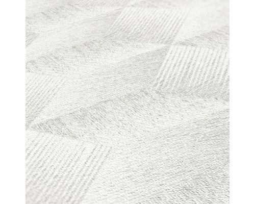 Close-up van een wit tapijt met geometrisch patroon