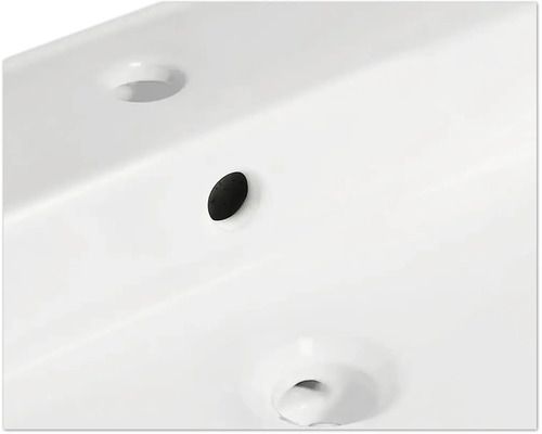 Detailopname van een wastafel met overloop