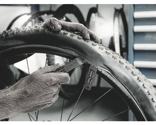 Close-up van een fietsband die wordt gemonteerd met bandenlichters