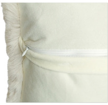 Detailweergave van een kussen met een rand van imitatiebont en een ritssluiting