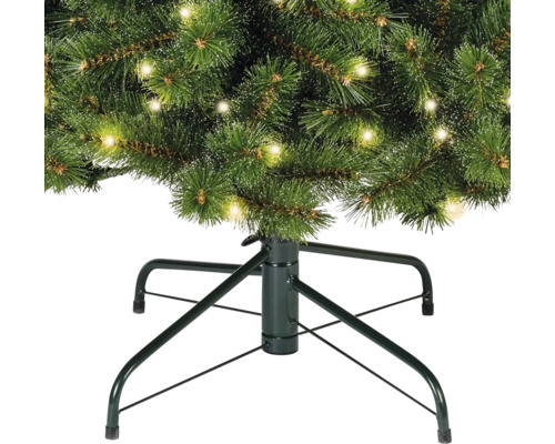 Detailopname van een kerstboom met verlichting en een kerstboomstandaard
