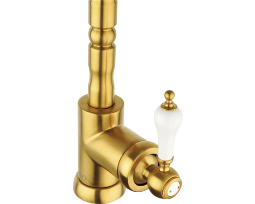 Goudkleurige wastafelkraan met witte handgreep