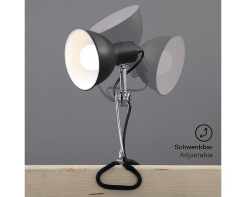 Klemspot met verstelbare lampkop op een houten tafel
