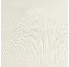 Close-up van een lichtgekleurd, gestructureerd behang.