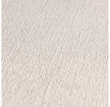 Close-up van een wit textielbehang met fijne structuur