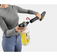 Een persoon verbindt een Kärcher pistool met een reinigingsreservoir.