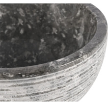 Close-up van een grijze stenen plantenschaal met een gegroefd oppervlak.