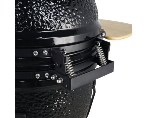 Detailweergave van een zwarte keramische barbecue met veermechanisme en houten plank