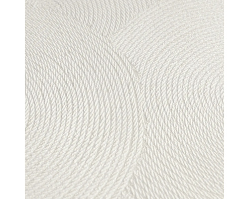 Close-up van een wit structuurbehang met cirkelvormig patroon