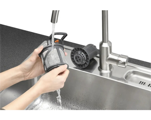 Reiniging van een vaatwasserfilter onder stromend water in een gootsteen.