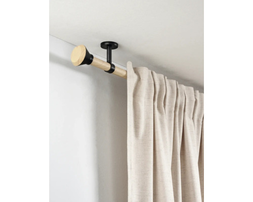 Gordijnroede voor plafondmontage van licht hout met zwarte metalen steunen en beige gordijn.