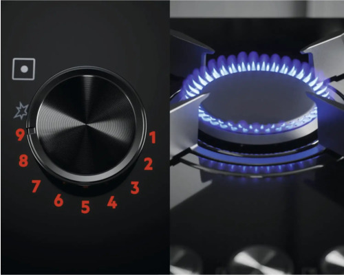 Close-up van een gaskookplaat met bedieningsknop en blauwe vlam