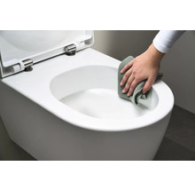 Iemand maakt een wit hangtoilet schoon met een doek.