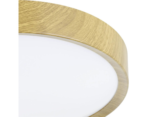 Detailopname van een ronde plafondlamp met houten frame