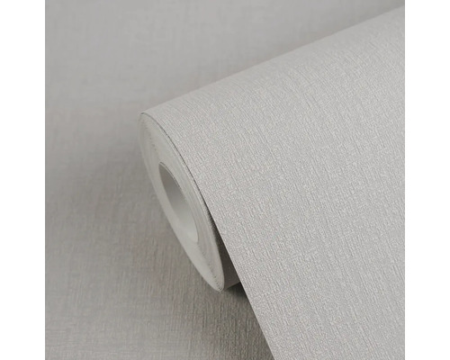 Lichtgrijs vliesbehang met linnenstructuur op een rol.