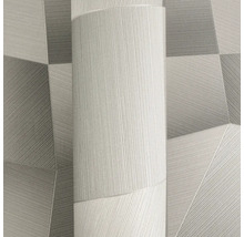 Vliesbehang met modern geometrisch patroon van driehoeken en fijne lijnenstructuur.