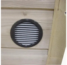 Rond ventilatierooster van kunststof ingebouwd in een houten wand.
