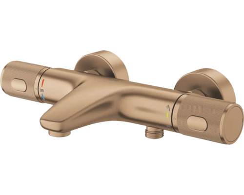 Thermostatische badkraan voor wandmontage met geborstelde afwerking, gekartelde handgrepen en markering voor 38 graden.