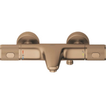 Wandgemonteerde thermostatische badkraan van metaal in bronslook met twee gekartelde handgrepen, temperatuurbegrenzing op 38 graden en omsteller.