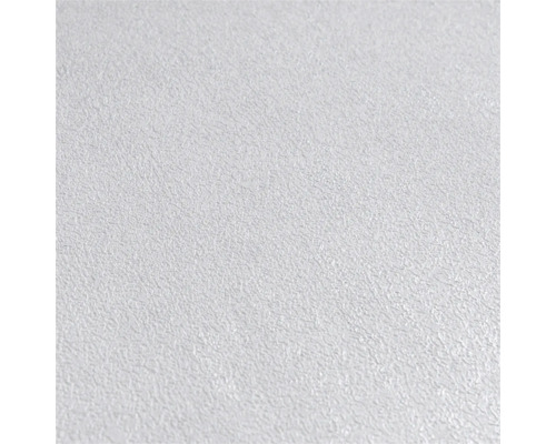 Detailopname van een wit vliesbehang met een gestructureerde stucwerklook.