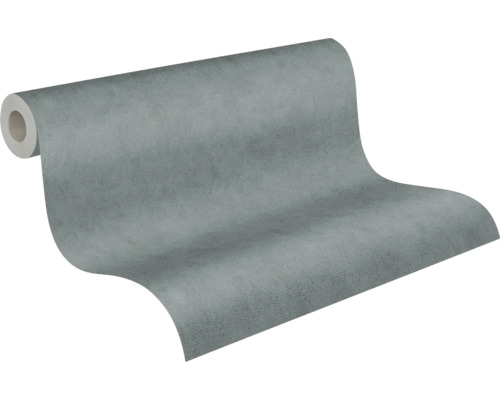 Vliesbehang met betonlook, gestructureerd, grijs, gedeeltelijk uitgerold.
