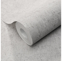 Gestructureerd vliesbehang op rol met betonlook en steenachtige oppervlakte.