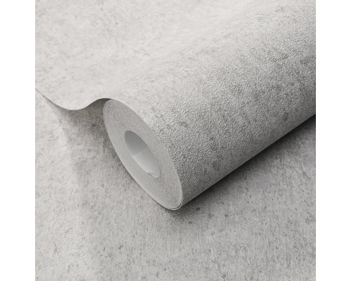 Gestructureerd vliesbehang op rol met betonlook en steenachtige oppervlakte.