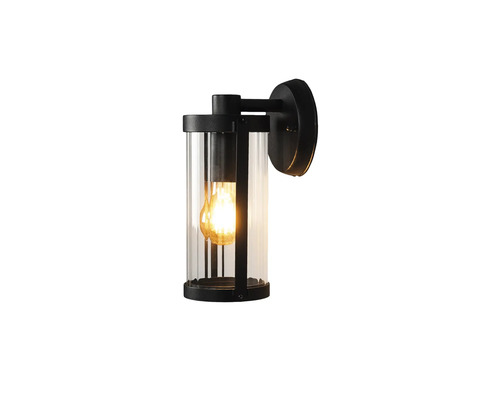 Moderne buitenwandlamp in cilindervorm van zwart metaal en helder glas met ingeschakelde lichtbron.