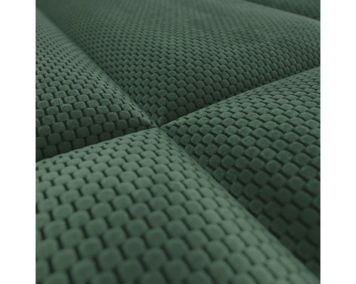 Detailopname van een groene structuurstof met wafelpatroon en een gewatteerd oppervlak.
