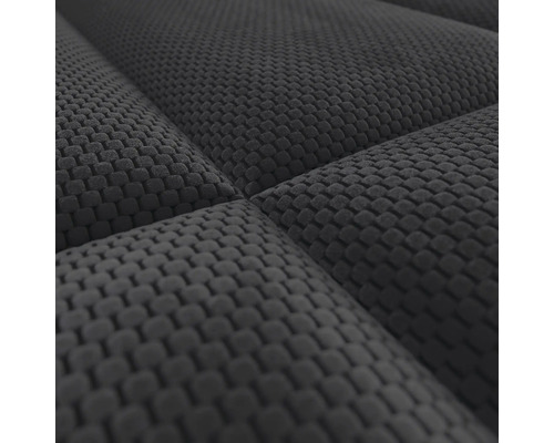 Detailweergave van een gestructureerde meubelstof met wafelpatroon.