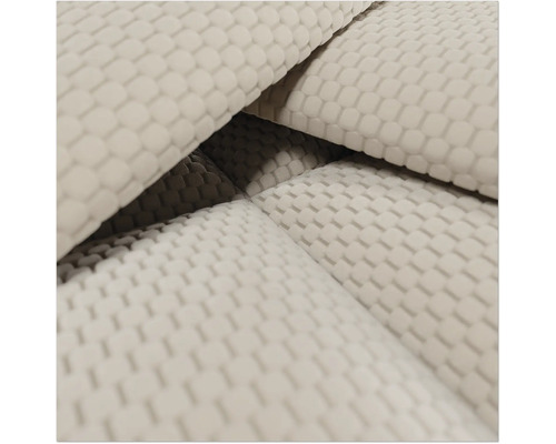 Close-up van gestructureerde meubelstof met een wafelpatroon.