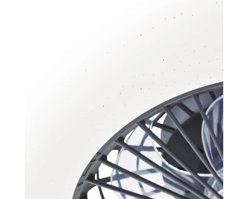 Detail van een plafondlamp met ventilator, witte kap met sterreneffect en donker beschermrooster.