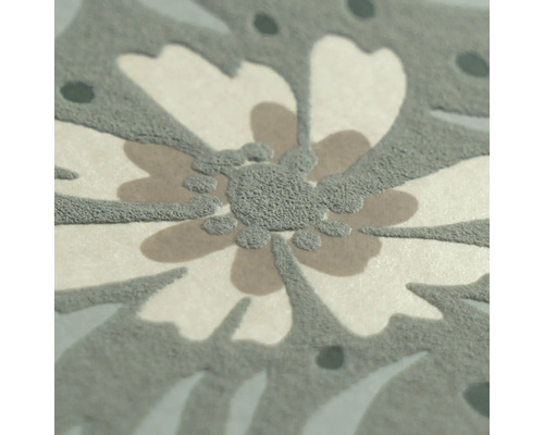 Close-up van vliesbehang met bloemenpatroon en gestructureerd oppervlak.