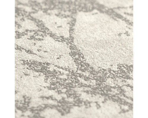 Detailopname van vliesbehang met grijs en wit abstract patroon en voelbare oppervlaktestructuur.