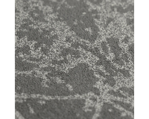 Detailopname van een tapijt met een gestructureerd oppervlak en een abstract patroon.