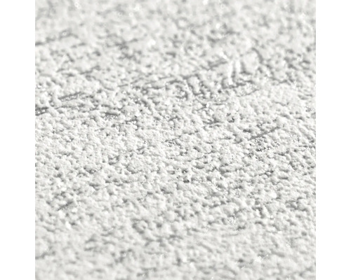 Close-up van een witte, grove stucwerkstructuur.
