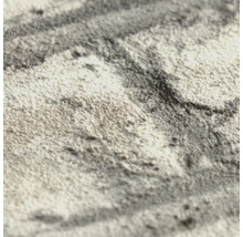 Detailopname van behang met een gestructureerd oppervlak en abstract patroon.