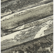 Detailopname van een getextureerd tapijt met marmerpatroon en zachte pool.