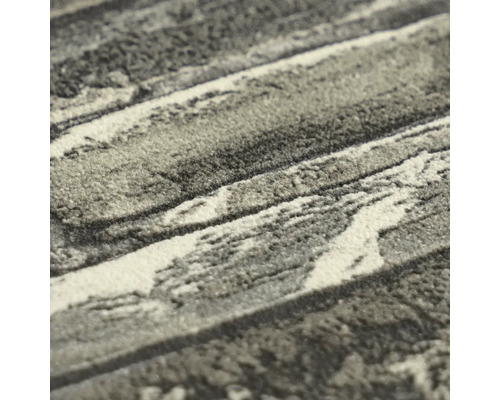 Detailopname van een getextureerd tapijt met marmerpatroon en zachte pool.