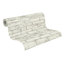 Licht vliesbehang met steenlook en baksteenmotief.