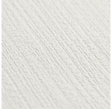 Detailopname van wit behang met een fijne, gestructureerde oppervlakte in pleisterlook.