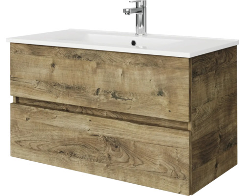 Wastafelonderkast in houtlook eiken met twee laden, witte wastafel en verchroomde kraan.