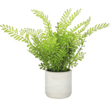 Kunstvaren in een geribbelde keramieken plantenpot als kamerplant voor decoratie