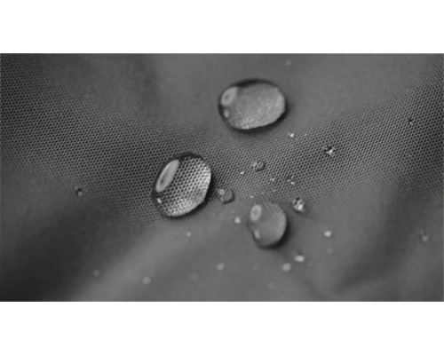 Waterdruppels parelen op een gestructureerde, waterafstotende stof.