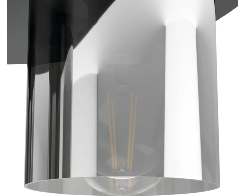 Detailweergave van een cilindrische lampenkap met een zichtbare filamentlamp.