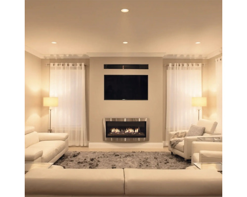 Woonkamer met wandhaard televisie en lichte zithoek in een modern interieur