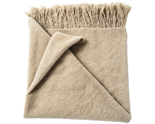 Zachte woondeken met franjes in beige.